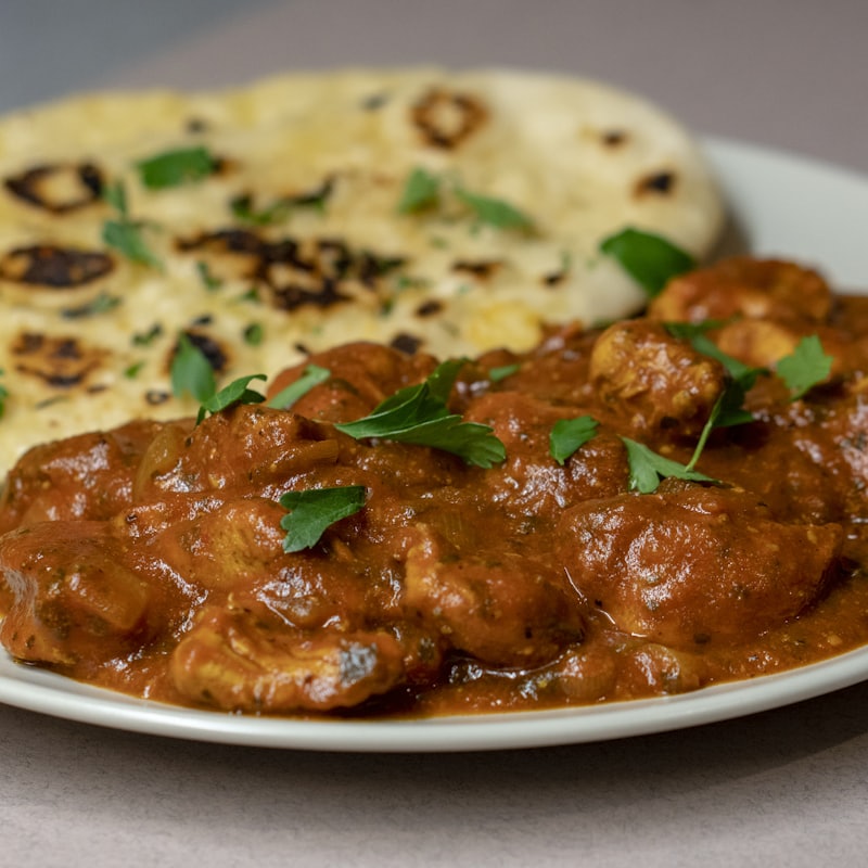 Rich curry served with fresh baked naan bread