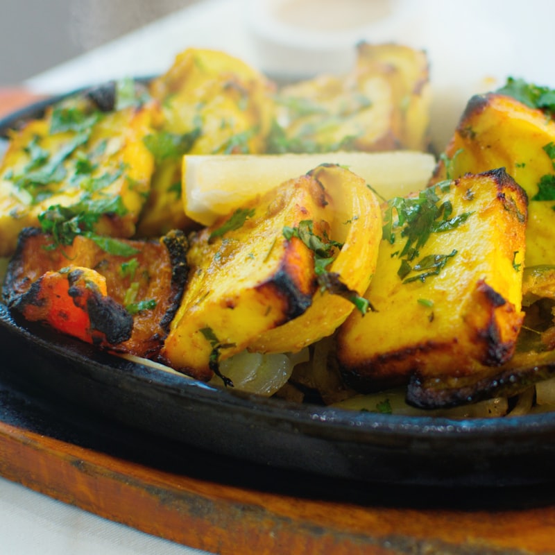 Tandoori paneer and peppers on a cast-iron sizzler platter